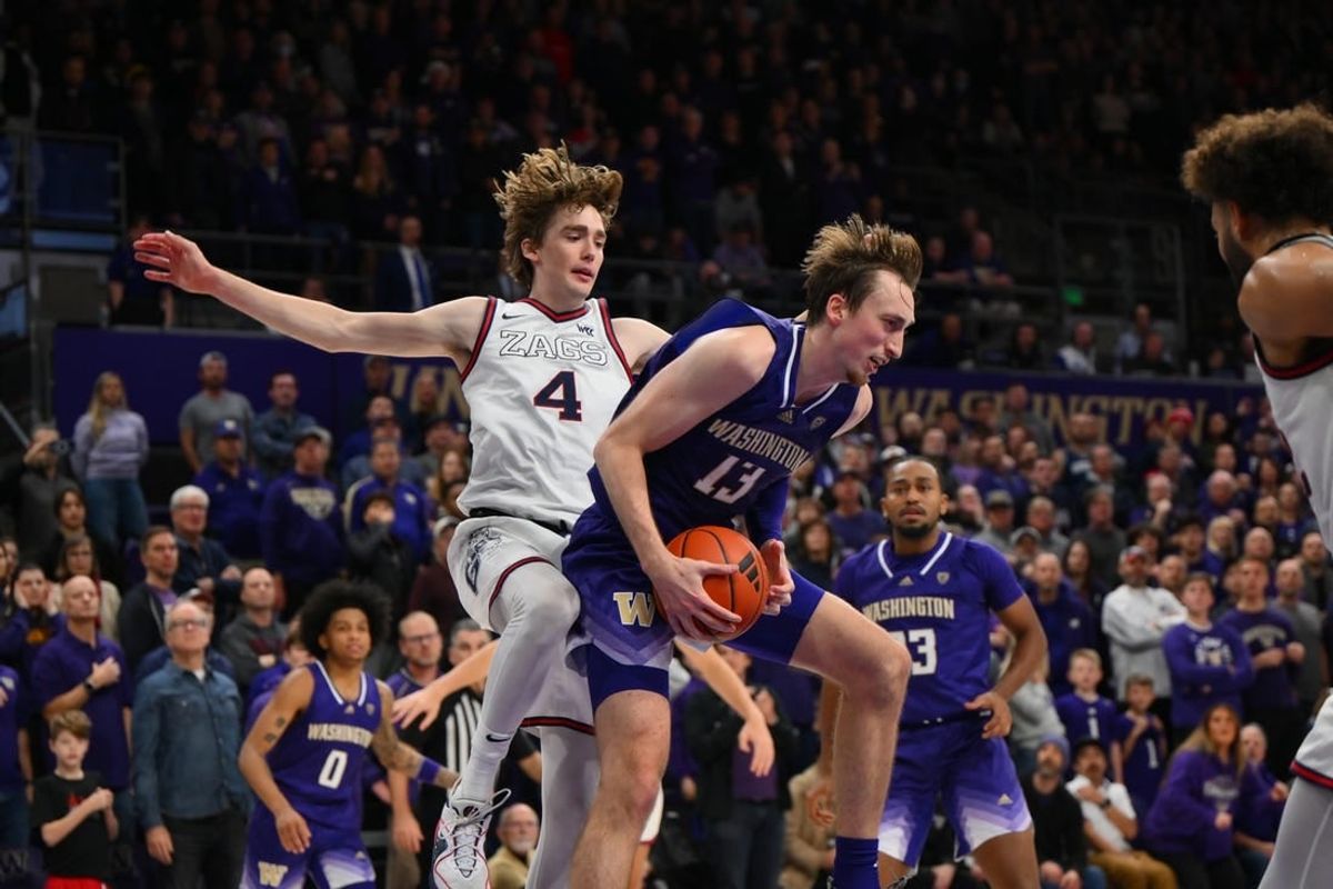 Dec 9, 2023; Seattle, Washington, USA; Washington Huskies forward Moses Wood (13) rebounds the ball in front of Gonzaga Bulldogs guard Dusty Stromer (4) during the second half at Alaska Airlines Arena at Hec Edmundson Pavilion.