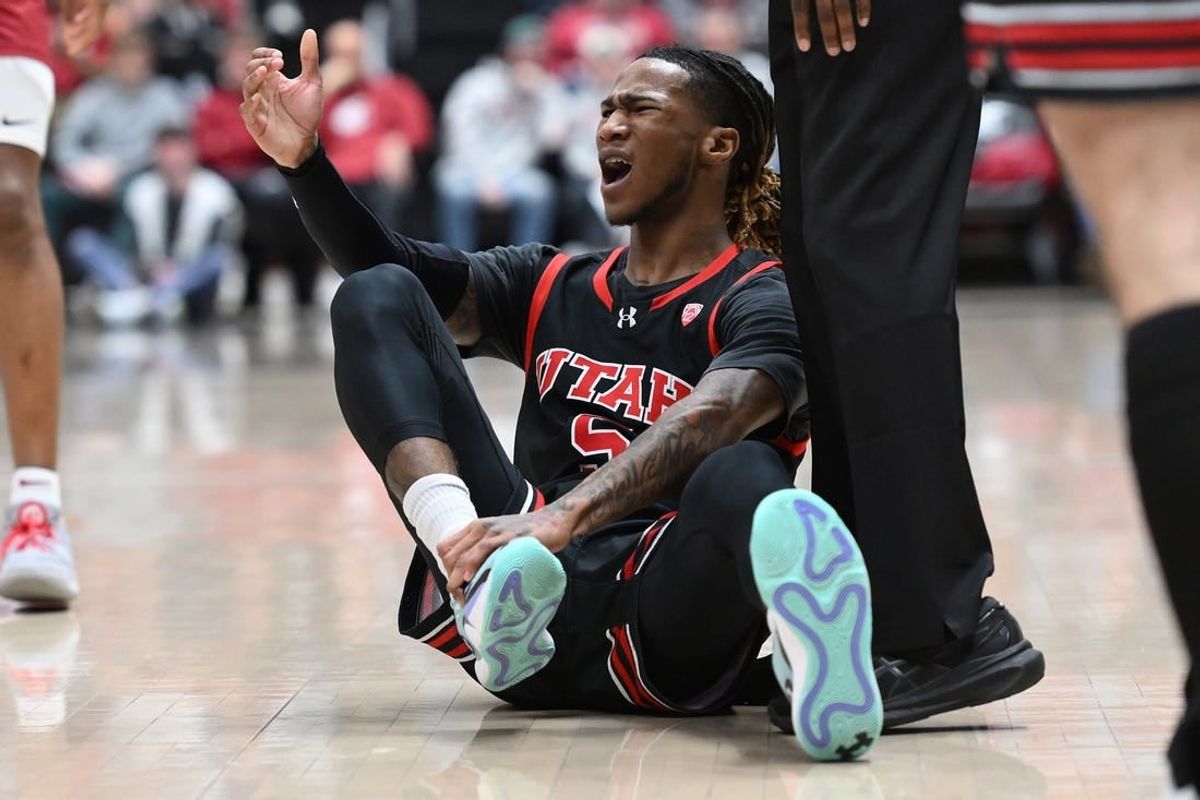 Jan 24, 2024; Pullman, Washington, USA; Utah Utes guard Deivon Smith (5) grab his ankle during a game against the Washington State Cougars in the first half at Friel Court at Beasley Coliseum.