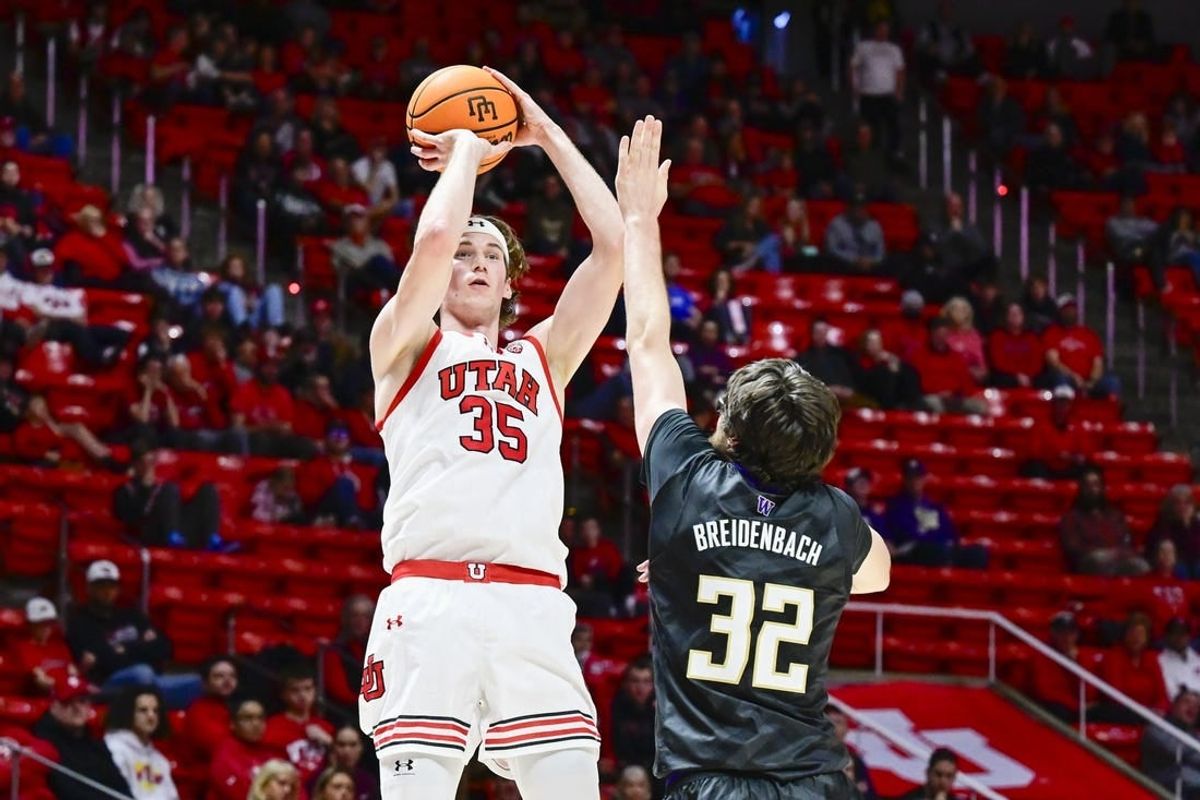 Dec 31, 2023; Salt Lake City, Utah, USA; Utah Utes center Branden Carlson (35) takes a shot over Washington Huskies forward Wilhelm Breidenbach (32) during the first half at the the Jon M. Huntsman Center.