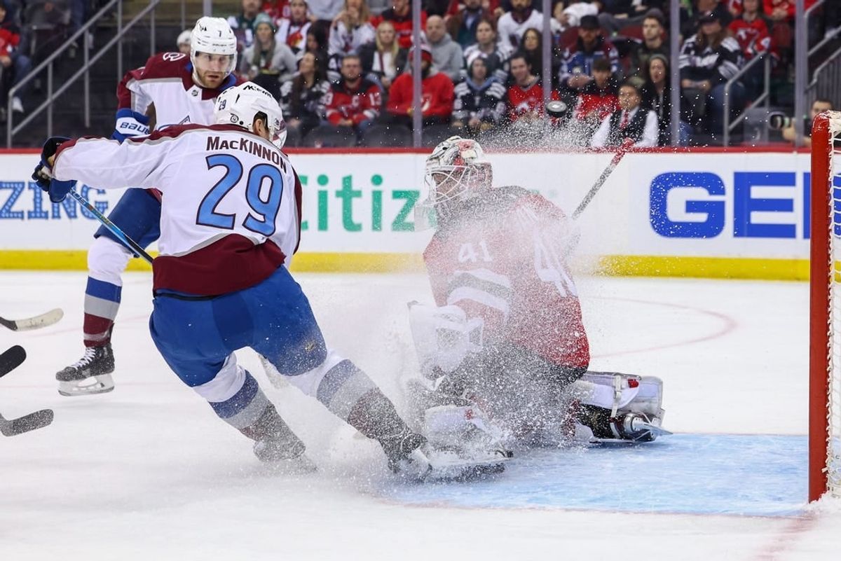 Feb 6, 2024; Newark, New Jersey, USA; New Jersey Devils goaltender Vitek Vanecek (41) makes a save on Colorado Avalanche center Nathan MacKinnon (29) during the first period at Prudential Center.