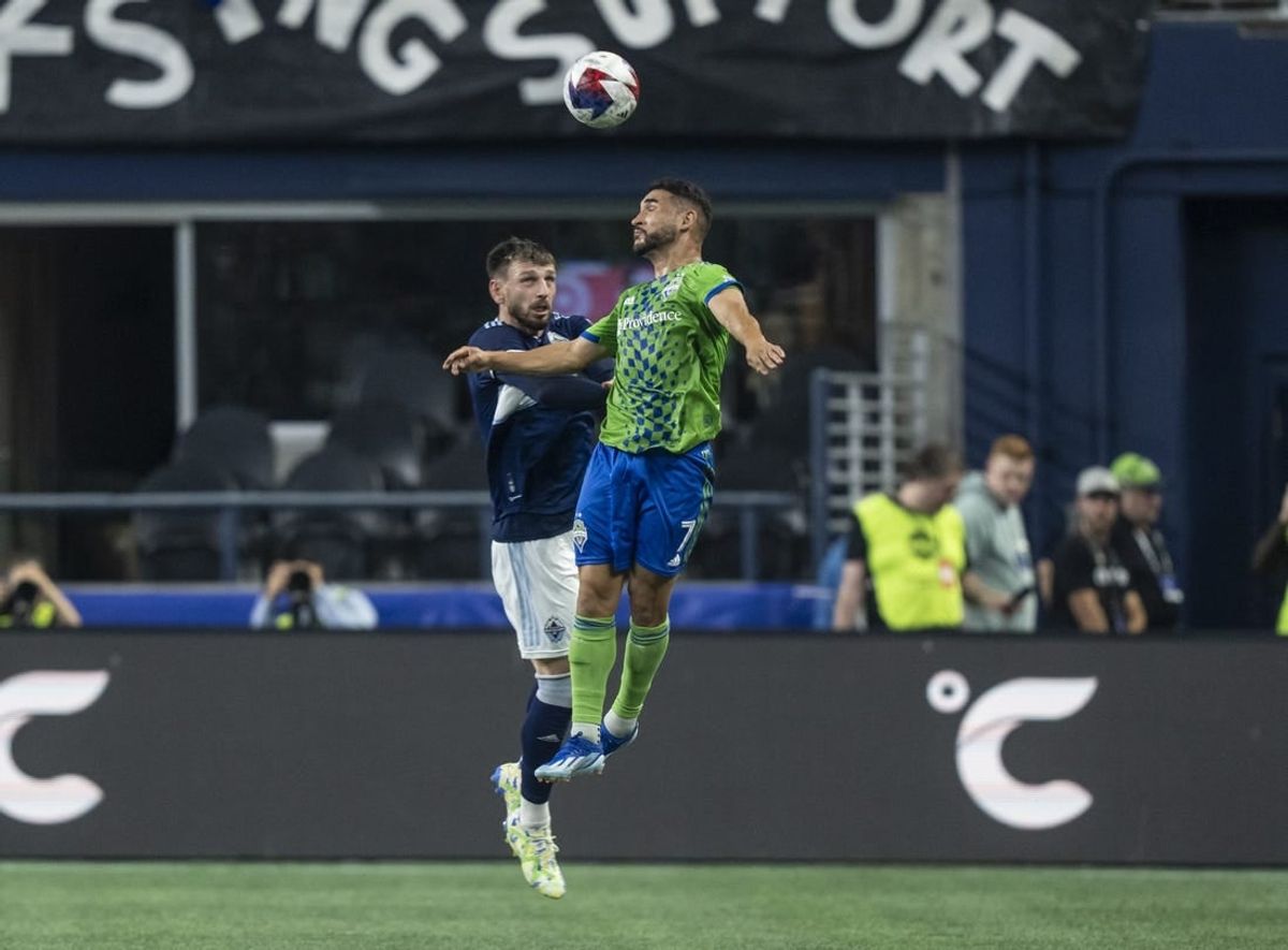 Oct 7, 2023; Seattle, Washington, USA; Seattle Sounders midfielder Cristian Roldan (7) and Vancouver Whitecaps defender Tristan Blackmon (6) go up for a header during the first half at Lumen Field.