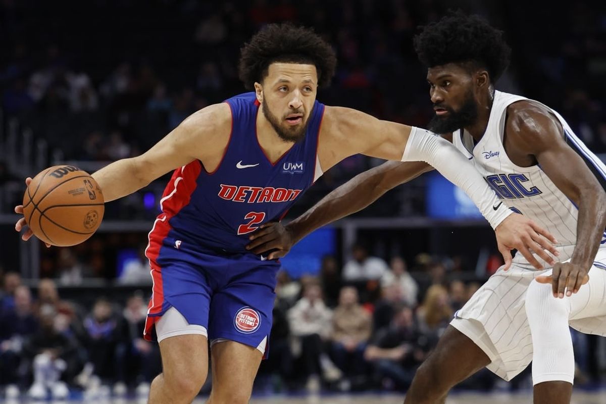 Feb 4, 2024; Detroit, Michigan, USA; Detroit Pistons guard Cade Cunningham (2) dribbles defended by Orlando Magic forward Jonathan Isaac (1) in the second half at Little Caesars Arena.