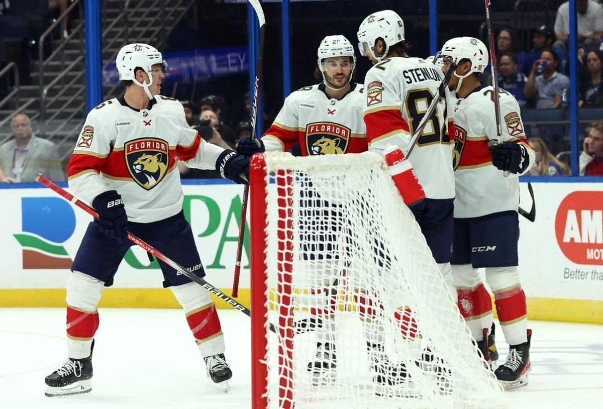 Oct 5, 2023; Tampa, Florida, USA; Florida Panthers left wing Ryan Lomberg (94) is congratulated after he scored a goal against the Tampa Bay Lightning  during the third period at Amalie Arena.