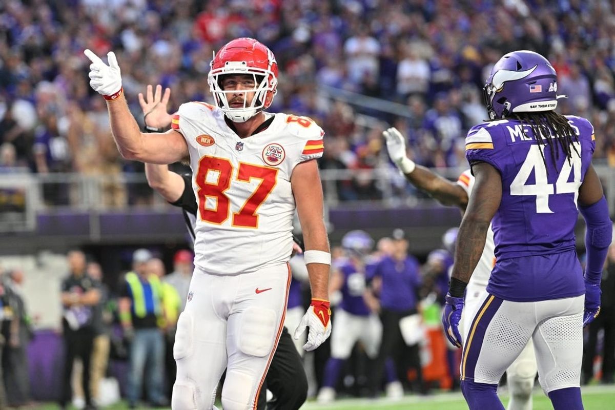 Oct 8, 2023; Minneapolis, Minnesota, USA; Kansas City Chiefs tight end Travis Kelce (87) reacts to a first down as Minnesota Vikings safety Josh Metellus (44) looks on during the third quarter at U.S. Bank Stadium.