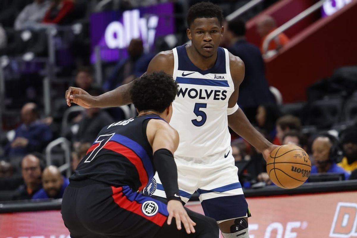 Jan 17, 2024; Detroit, Michigan, USA;  Minnesota Timberwolves guard Anthony Edwards (5) dribbles defended by Detroit Pistons guard Killian Hayes (7) in the first half at Little Caesars Arena.