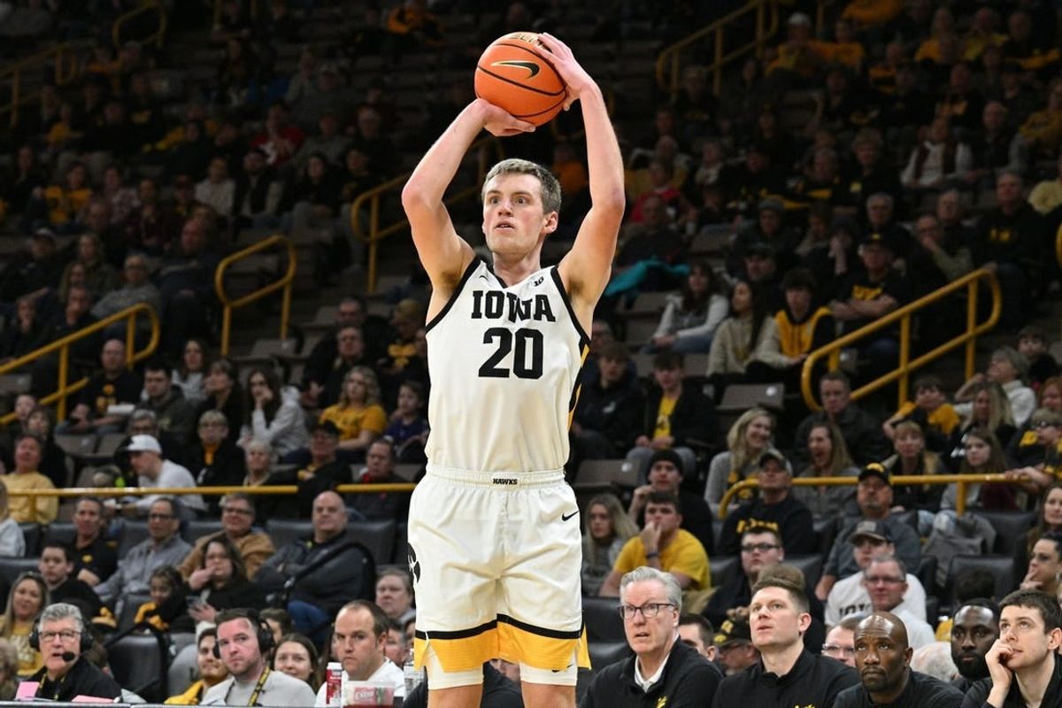 Feb 11, 2024; Iowa City, Iowa, USA; Iowa Hawkeyes forward Payton Sandfort (20) attempts a three point basket against the Minnesota Golden Gophers during the second half at Carver-Hawkeye Arena.