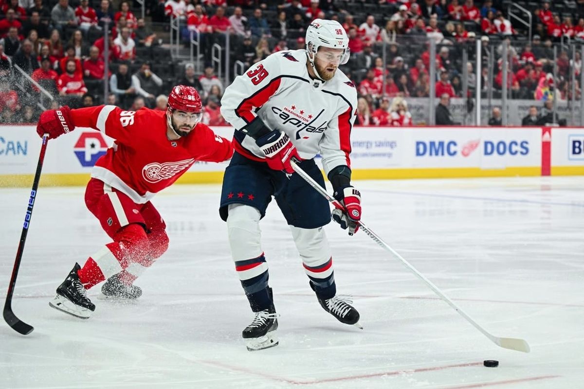 Feb 27, 2024; Detroit, Michigan, USA; Washington Capitals right wing Anthony Mantha (39) brings the puck up ice against Detroit Red Wings defenseman Jake Walman (96) during the first period at Little Caesars Arena.