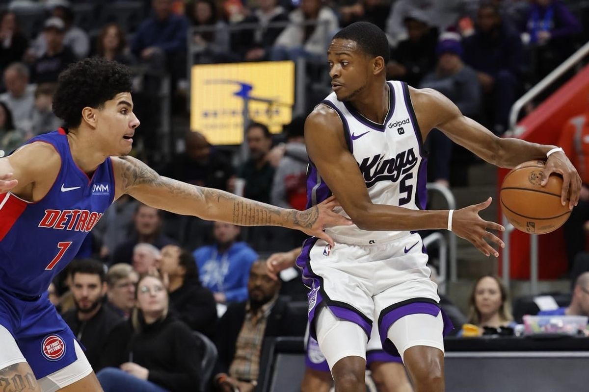 Jan 9, 2024; Detroit, Michigan, USA;  Sacramento Kings guard De'Aaron Fox (5) dribbles defended by Detroit Pistons guard Killian Hayes (7) in the first half at Little Caesars Arena.
