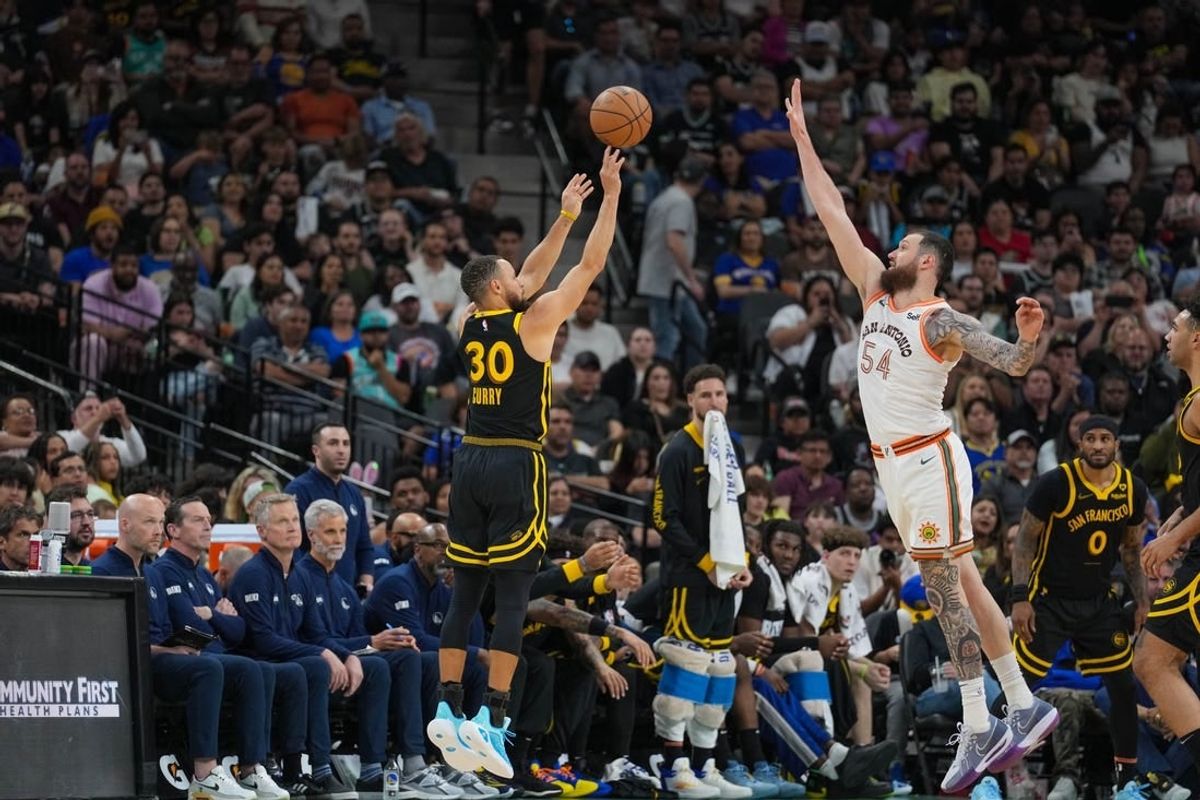 Mar 31, 2024; San Antonio, Texas, USA;  San Antonio Spurs forward Julian Champagnie (30) shoots over San Antonio Spurs forward Sandro Mamukelashvili (54) in the second half at Frost Bank Center.