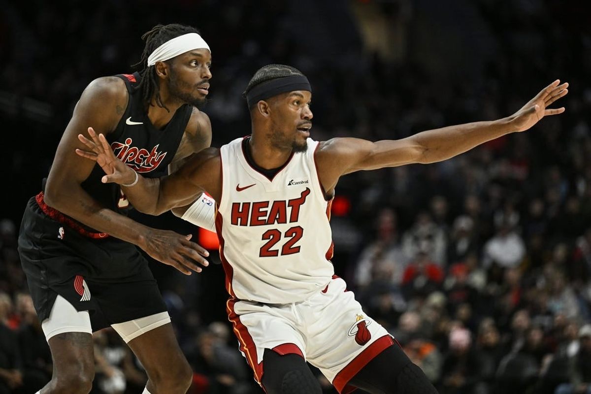 Feb 27, 2024; Portland, Oregon, USA; Miami Heat forward Jimmy Butler (22) reaches for a pass during the second half against Portland Trail Blazers forward Jerami Grant (9) at Moda Center.