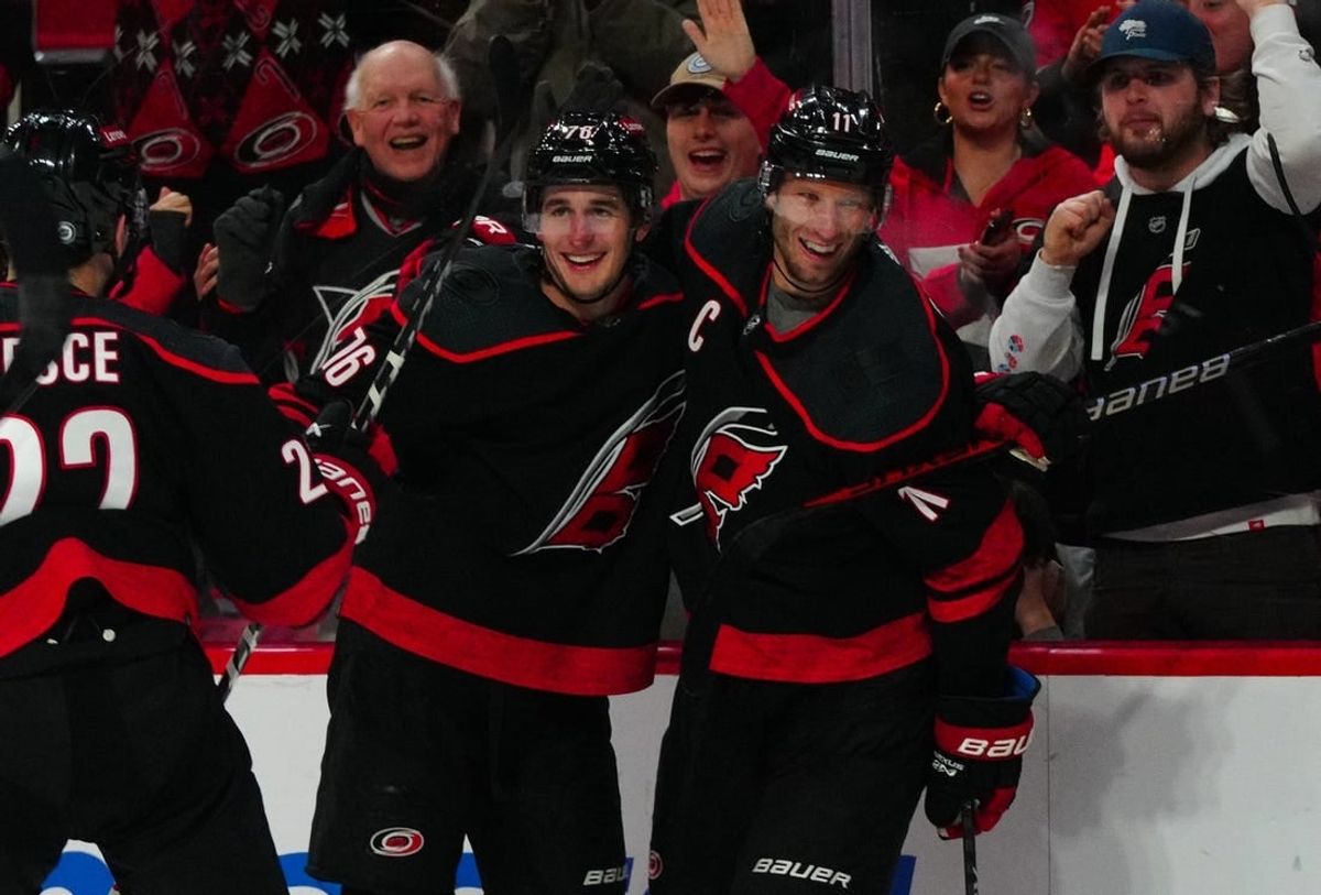 Dec 19, 2023; Raleigh, North Carolina, USA; Carolina Hurricanes defenseman Brady Skjei (76) celebrates his goal with center Jordan Staal (11) against the Vegas Golden Knights during the third period at PNC Arena.