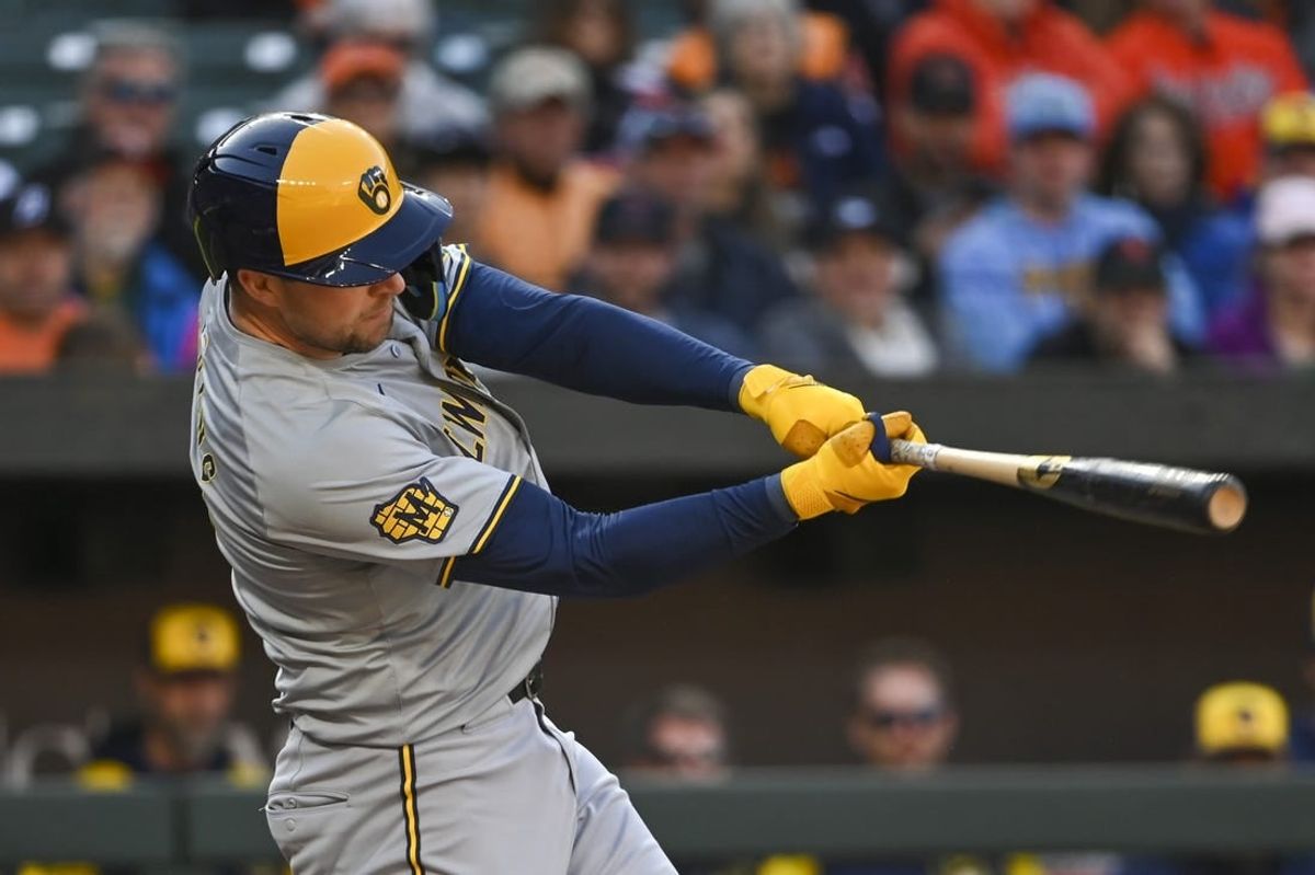 Apr 13, 2024; Baltimore, Maryland, USA;  Milwaukee Brewers first baseman Rhys Hoskins (12) swings through a third inning rbi single against the Baltimore Orioles at Oriole Park at Camden Yards.