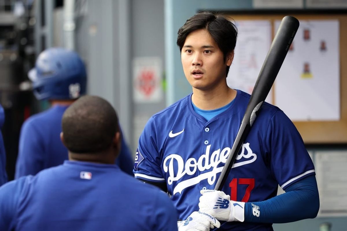 Mar 24, 2024; Los Angeles, California, USA;  Los Angeles Dodgers designated hitter Shohei Ohtani (17) holds a bat in the dugout prior to the game against the Los Angeles Angels at Dodger Stadium.