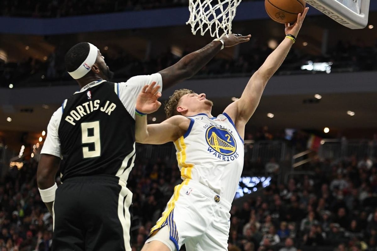 Jan 13, 2024; Milwaukee, Wisconsin, USA; Golden State Warriors guard Brandin Podziemski (2) puts up a shot against Milwaukee Bucks forward Bobby Portis (9) in the first half at Fiserv Forum.