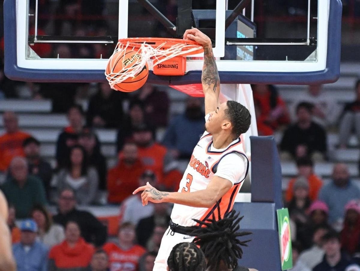Jan 23, 2024; Syracuse, New York, USA; Syracuse Orange forward Benny Williams (13) dunks the ball against the Florida State Seminoles in the first half at the JMA Wireless Dome.