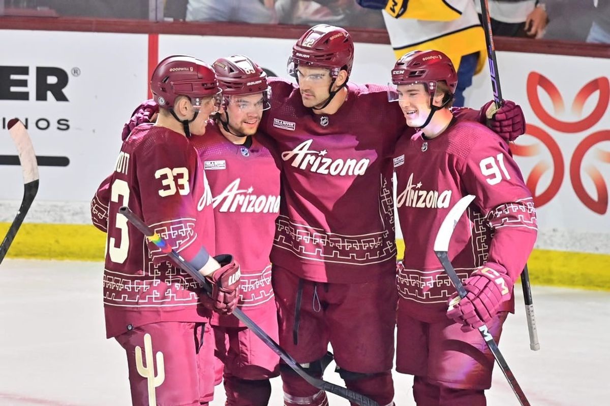 Mar 28, 2024; Tempe, Arizona, USA; Arizona Coyotes center Jack McBain (22) celebrates with right wing Josh Doan (91), left wing Matias Maccelli (63) and defenseman Travis Dermott (33) after scoring a goal in the first period against the Nashville Predators at Mullett Arena.
