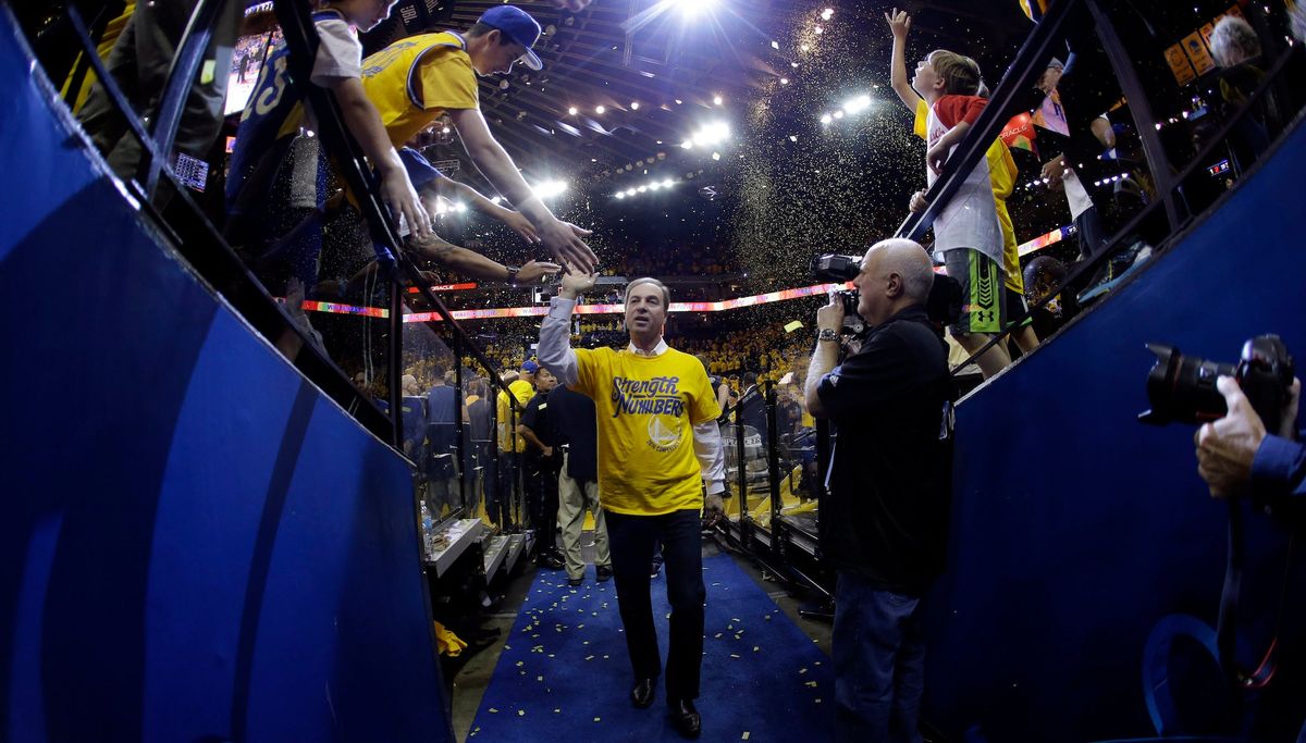 Young fans give high-fives to their idol, the star of the Golden State Warriors, Joe Lacob. (Photo credit: Marcio Jose Sanchez/ [object Object] )