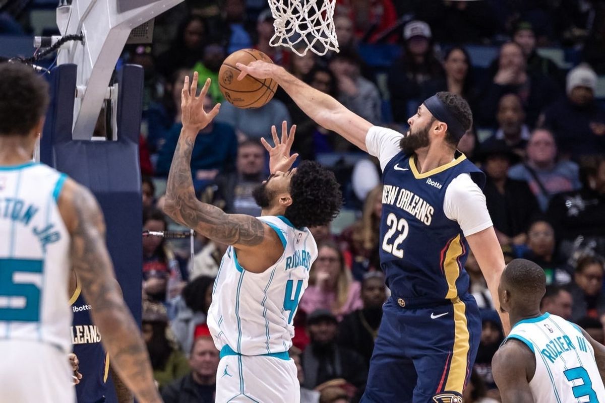 Jan 17, 2024; New Orleans, Louisiana, USA;  New Orleans Pelicans forward Larry Nance Jr. (22) blocks the shot of Charlotte Hornets center Nick Richards (4) during the first half at Smoothie King Center.