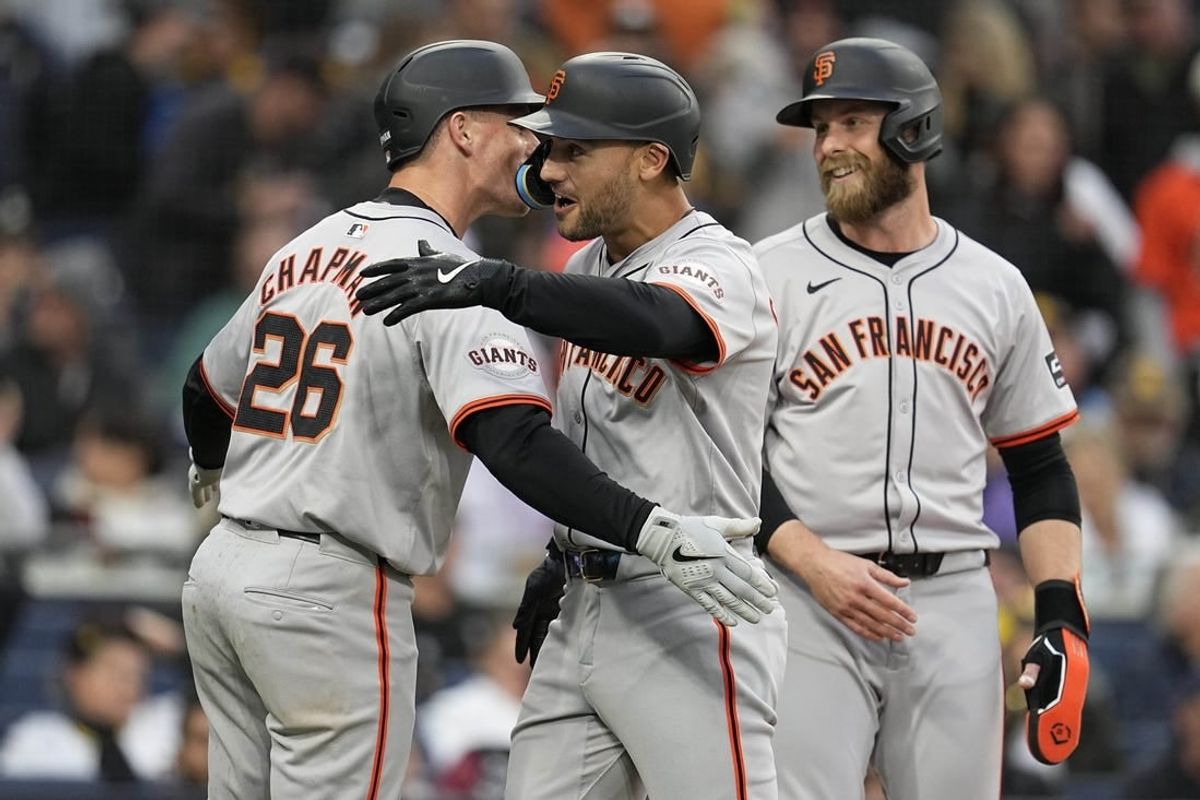 Mar 30, 2024; San Diego, California, USA; San Francisco Giants left fielder Michael Conforto (center) is congratulated by third baseman Matt Chapman (26) after hitting a grand slam home run against the San Diego Padres during the eighth inning at Petco Park.