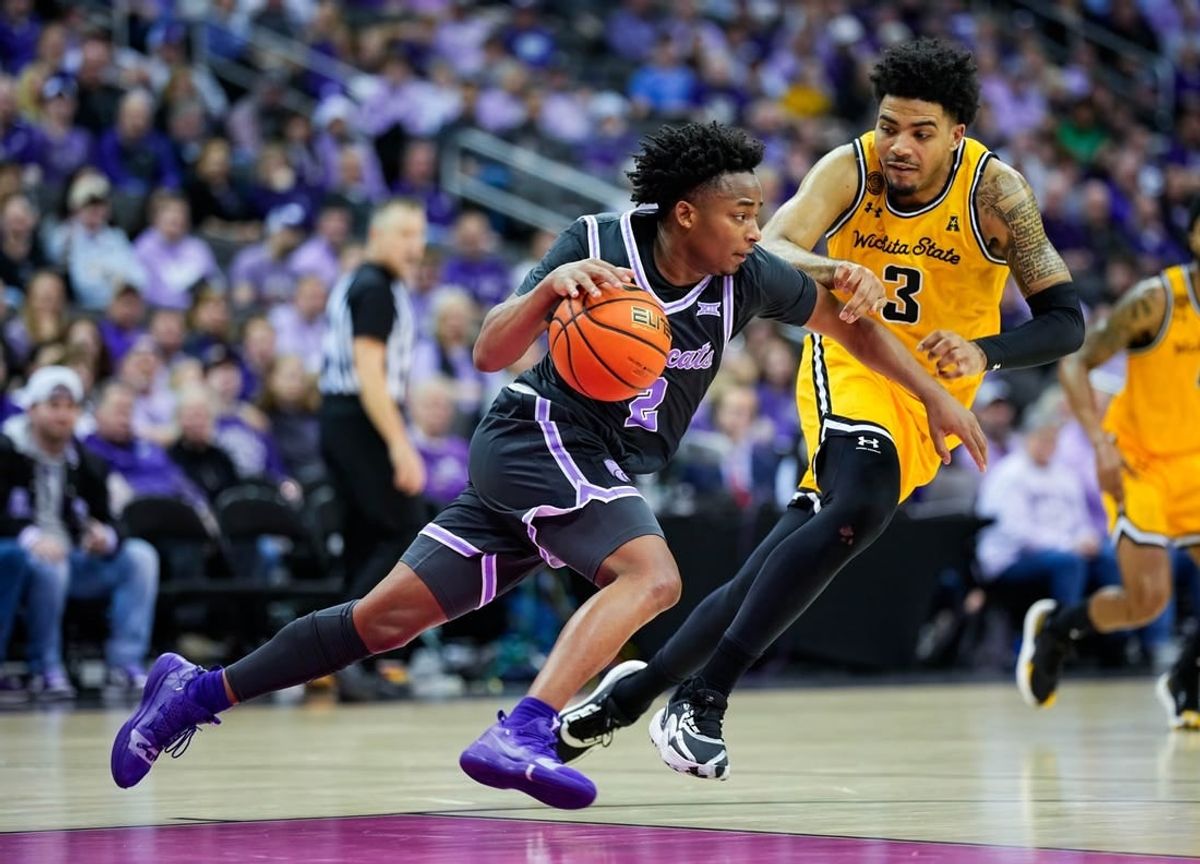 Dec 21, 2023; Kansas City, Missouri, USA; Kansas State Wildcats guard Tylor Perry (2) dribbles the ball against Wichita State Shockers forward Ronnie DeGray III (3) during the second half at T-Mobile Center.