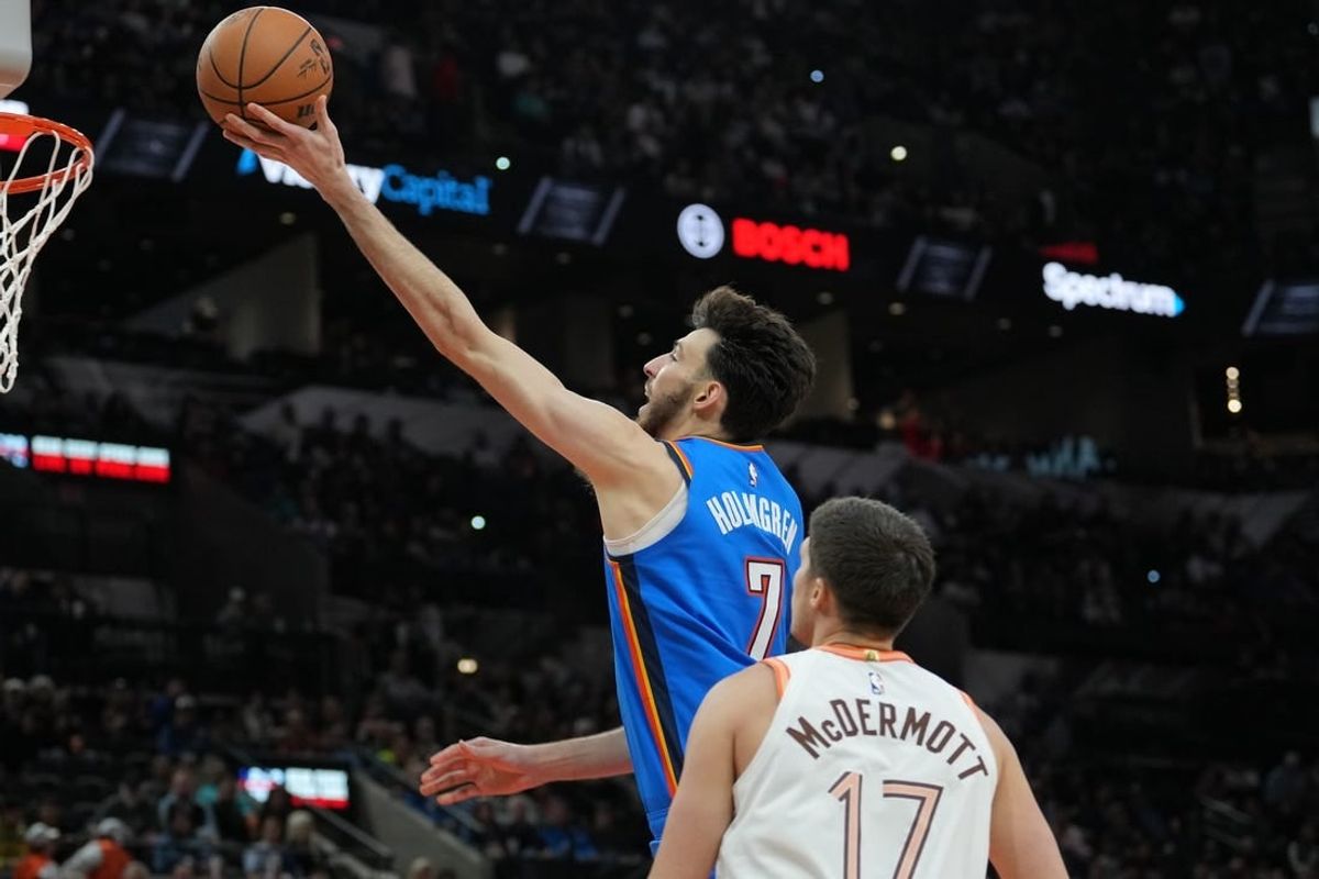 Jan 24, 2024; San Antonio, Texas, USA;  Oklahoma City Thunder forward Chet Holmgren (7) shoots in front of San Antonio Spurs forward Doug McDermott (17) in the second half at Frost Bank Center.