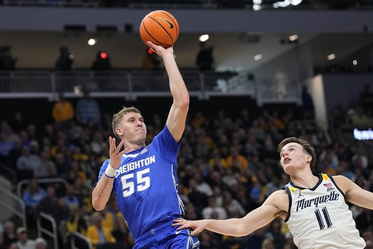 Dec 30, 2023; Milwaukee, Wisconsin, USA;  Creighton Bluejays guard Baylor Scheierman (55) shoots over Marquette Golden Eagles guard Tyler Kolek (11) during the first half at Fiserv Forum.