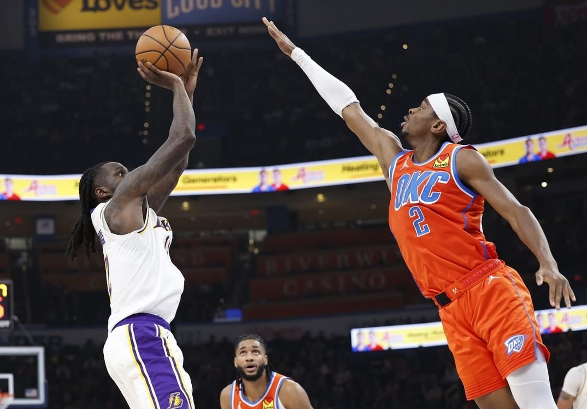 Dec 23, 2023; Oklahoma City, Oklahoma, USA; Los Angeles Lakers forward Taurean Prince (12) shoots as Oklahoma City Thunder guard Shai Gilgeous-Alexander (2) defends during the second quarter at Paycom Center.