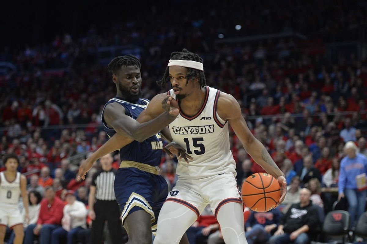 Jan 30, 2024; Dayton, Ohio, USA;  Dayton Flyers forward DaRon Holmes II (15) drives to the basket against George Washington center Babatunde Akingbola (23) during a game at University of Dayton Arena.