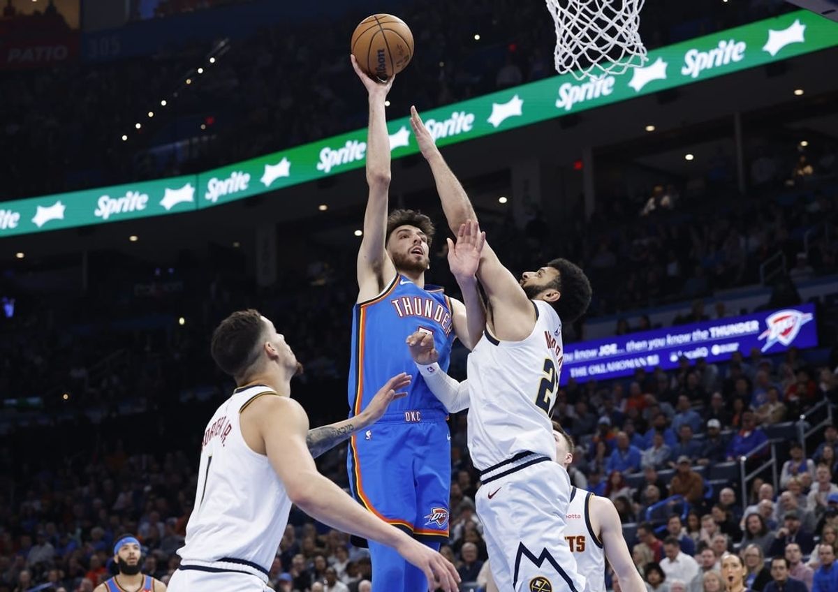 Jan 31, 2024; Oklahoma City, Oklahoma, USA; Oklahoma City Thunder forward Chet Holmgren (7) shoots as Denver Nuggets guard Jamal Murray (27) defends during the second half at Paycom Center.