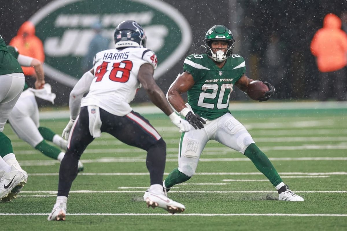 Dec 10, 2023; East Rutherford, New Jersey, USA; New York Jets running back Breece Hall (20) carries the ball asHouston Texans linebacker Christian Harris (48) pursues during the first half at MetLife Stadium.