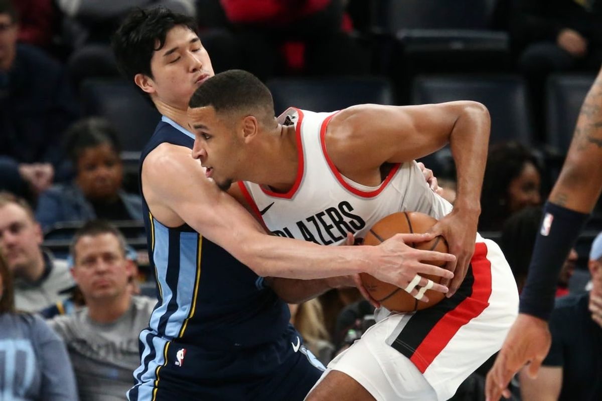 Mar 1, 2024; Memphis, Tennessee, USA; Portland Trail Blazers forward Kris Murray (8) drives to the basket as Memphis Grizzlies forward Yuta Watanabe (18) defends during the second half at FedExForum.