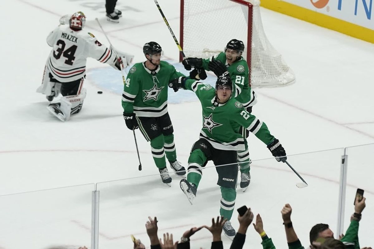 Dec 29, 2023; Dallas, Texas, USA; Dallas Stars center Roope Hintz (24) reacts with defenseman Miro Heiskanen (4) and left wing Jason Robertson (21) in front of Chicago Blackhawks goaltender Petr Mrazek (34) after scoring the game winning goal during overtime at American Airlines Center.