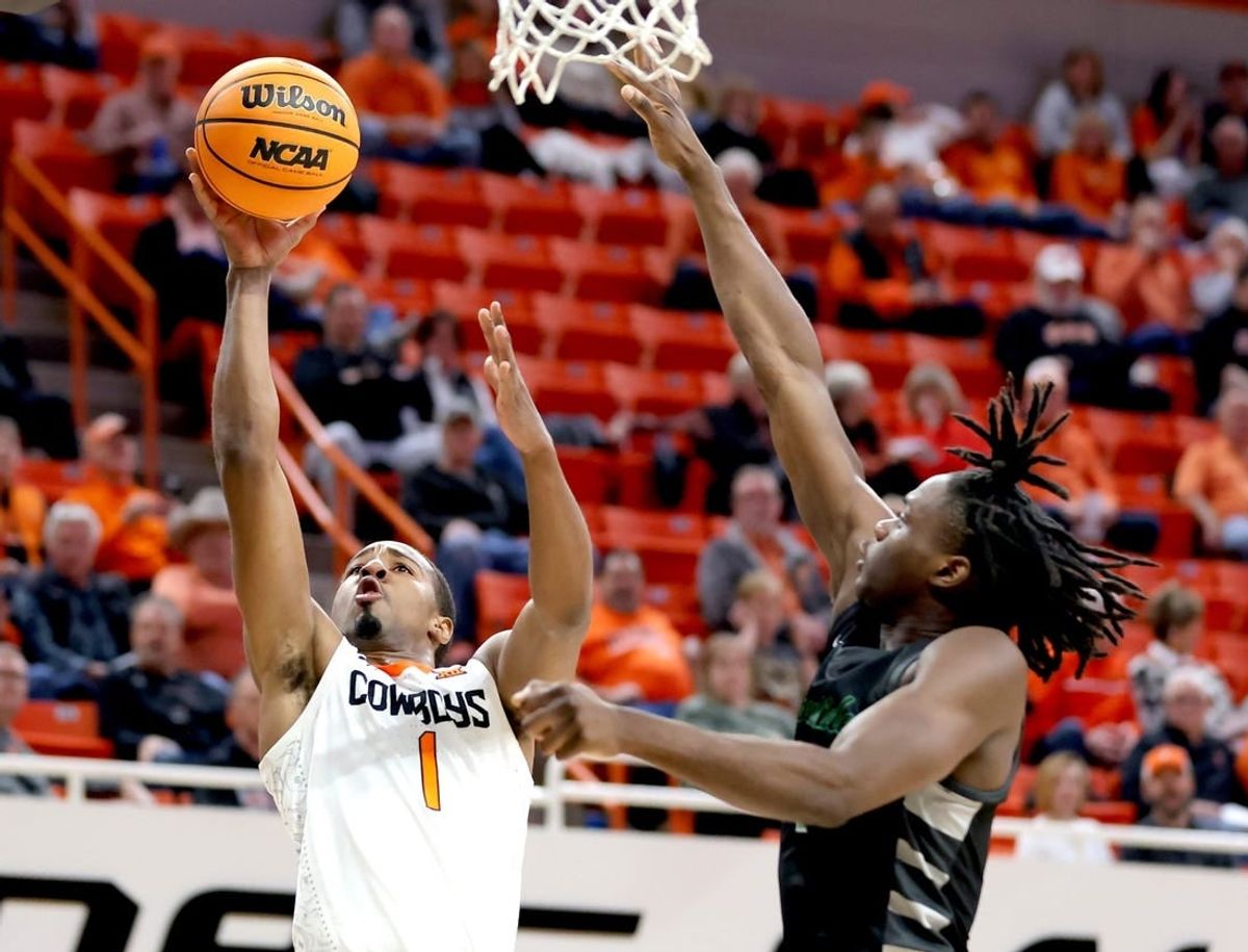 Oklahoma State's Bryce Thompson (1) goes up for a basket as Chicago State's Wesley Cardet Jr. (1) defends of the college basketball game between the Oklahoma State Cowboys and the Chicago State Cougars at Gallagher-Iba Arena in Stillwater, Okla., Wednesday, Jan. 3, 2024.