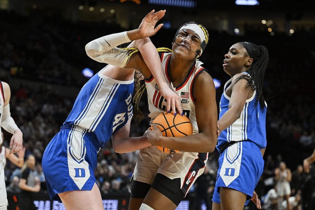 Mar 30, 2024; Portland, OR, USA; UConn Huskies forward Aaliyah Edwards (3) is fouled by Duke Blue Devils center Kennedy Brown (42) during the second half in the semifinals of the Portland Regional of the 2024 NCAA Tournament at the Moda Center.