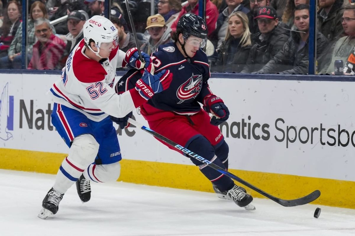 Nov 29, 2023; Columbus, Ohio, USA;  Columbus Blue Jackets center Alexandre Texier (42) skates with the puck against Montreal Canadiens defenseman Justin Barron (52) in the second period at Nationwide Arena.