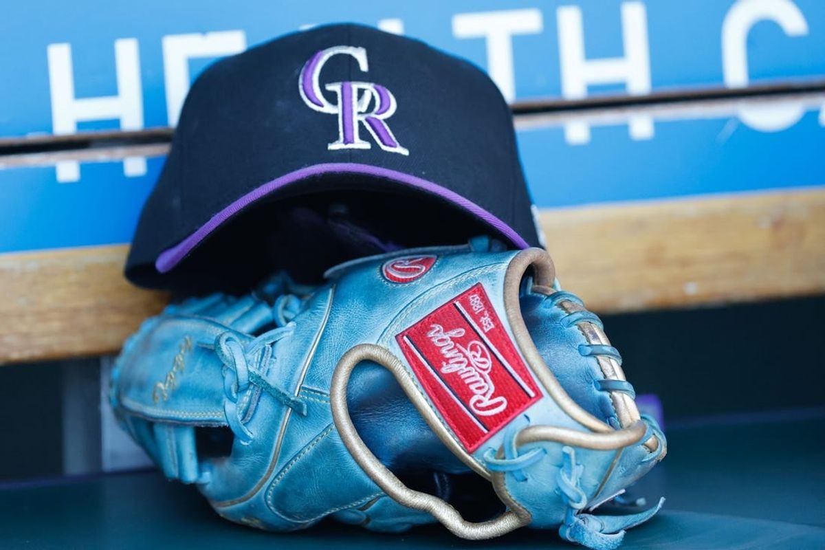 Apr 23, 2022; Detroit, Michigan, USA;  Colorado Rockies cap and glove in the dugout during the game against the Detroit Tigers at Comerica Park.