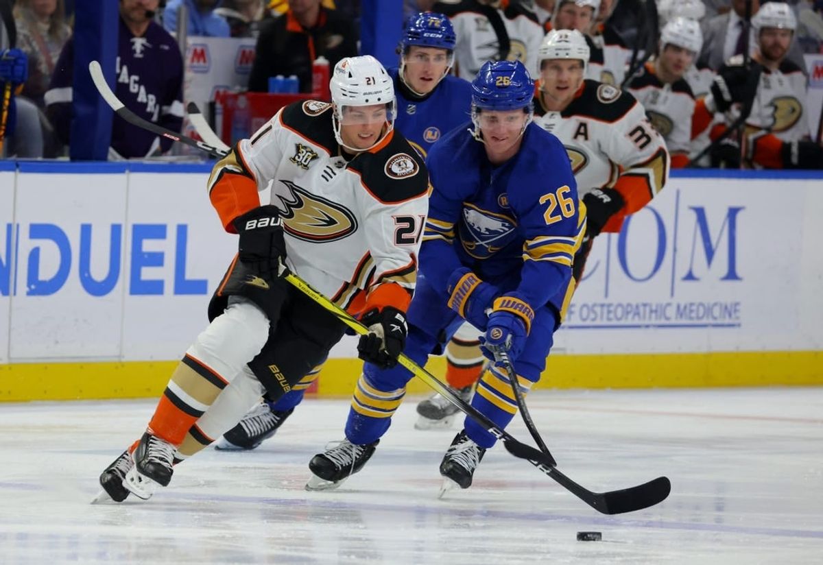 Feb 19, 2024; Buffalo, New York, USA;  Anaheim Ducks center Isac Lundestrom (21) looks to control the puck as Buffalo Sabres defenseman Rasmus Dahlin (26) defends during the first period at KeyBank Center.