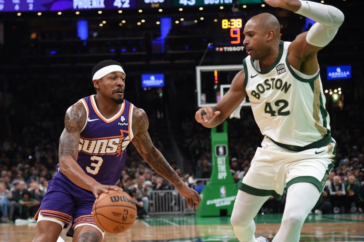 Mar 14, 2024; Boston, Massachusetts, USA;  Phoenix Suns guard Bradley Beal (3) controls the ball while Boston Celtics center Al Horford (42) defends during the first half at TD Garden.