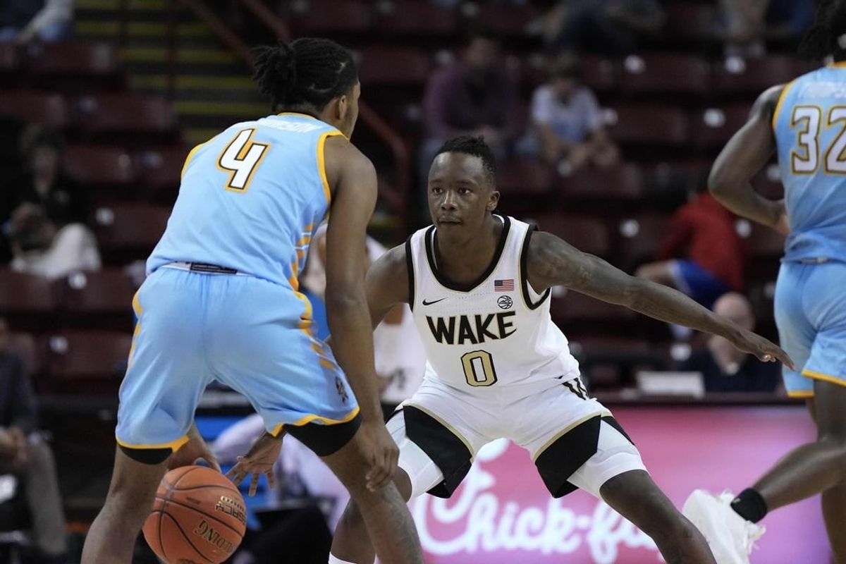 Nov 17, 2023; Charleston, SC, USA; Wake Forest Demon Deacons guard Kevin Miller (0) defends against Towson Tigers guard Dylan Williamson (4) in the second half at TD Arena.