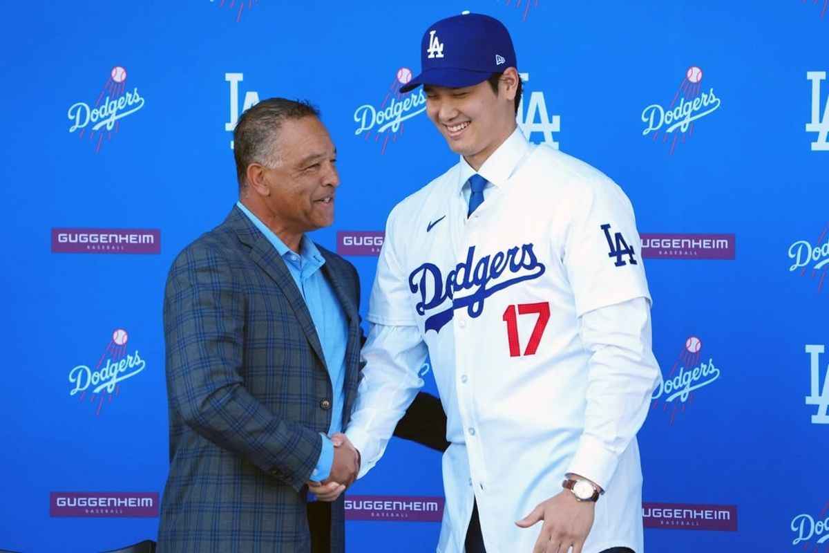 Dec 14, 2023; Los Angeles, CA, USA; Los Angeles Dodgers designated hitter Shohei Ohtani (17) shakes hands with manager Dave Roberts at press conference at Dodger Stadium.