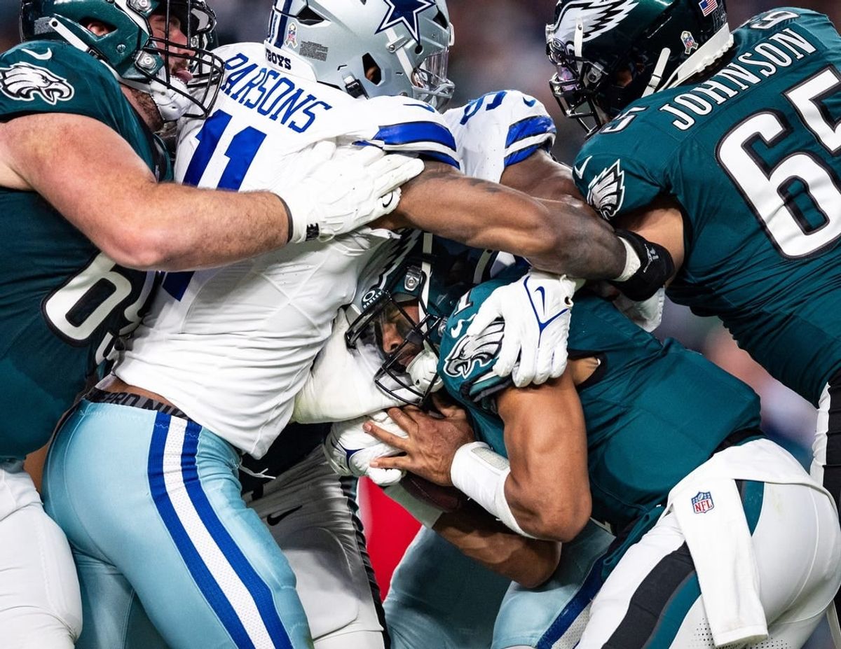 Philadelphia Eagles quarterback Jalen Hurts (1) is tackled by Dallas Cowboys linebacker Micah Parsons (11) during the first quarter at Lincoln Financial Field.