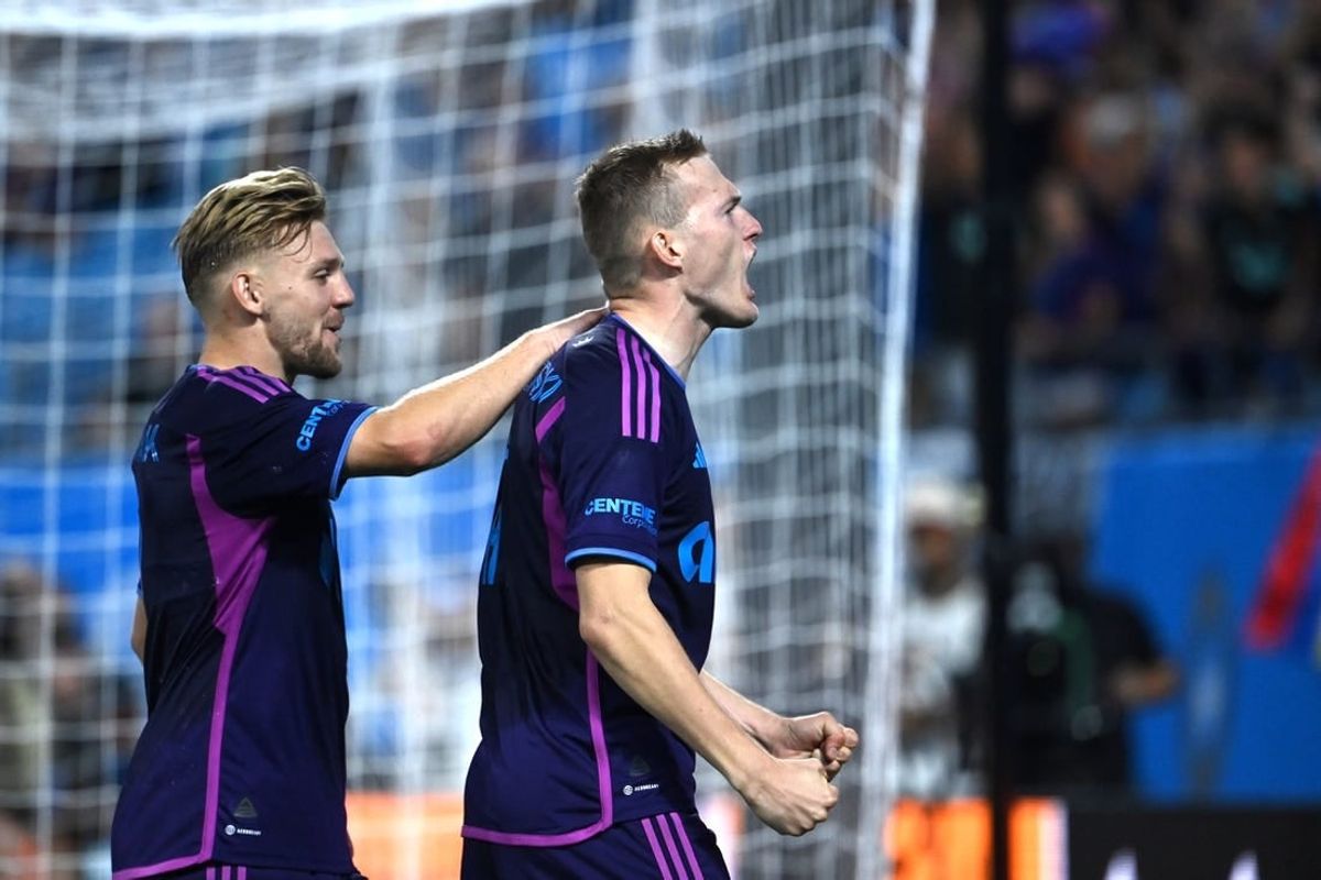 Oct 4, 2023; Charlotte, North Carolina, USA; Charlotte FC forward Karol   widerski (11) celebrates with midfielder Kamil J    wiak (7) after scoring his second goal in the first half at Bank of America Stadium.