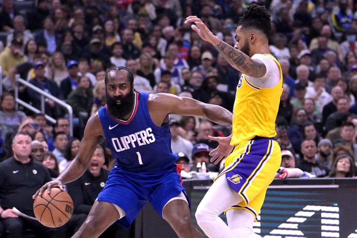 Jan 23, 2024; Los Angeles, California, USA; Los Angeles Clippers guard James Harden (1) is defended by Los Angeles Lakers guard D'Angelo Russell (1) in the first half at Crypto.com Arena.
