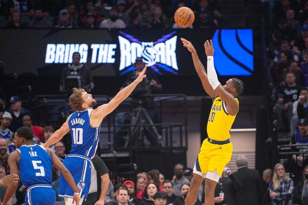Jan 18, 2024; Sacramento, California, USA; Indiana Pacers guard Bennedict Mathurin (00) takes a shot over Sacramento Kings forward Domantas Sabonis (10) during the first quarter at Golden 1 Center.