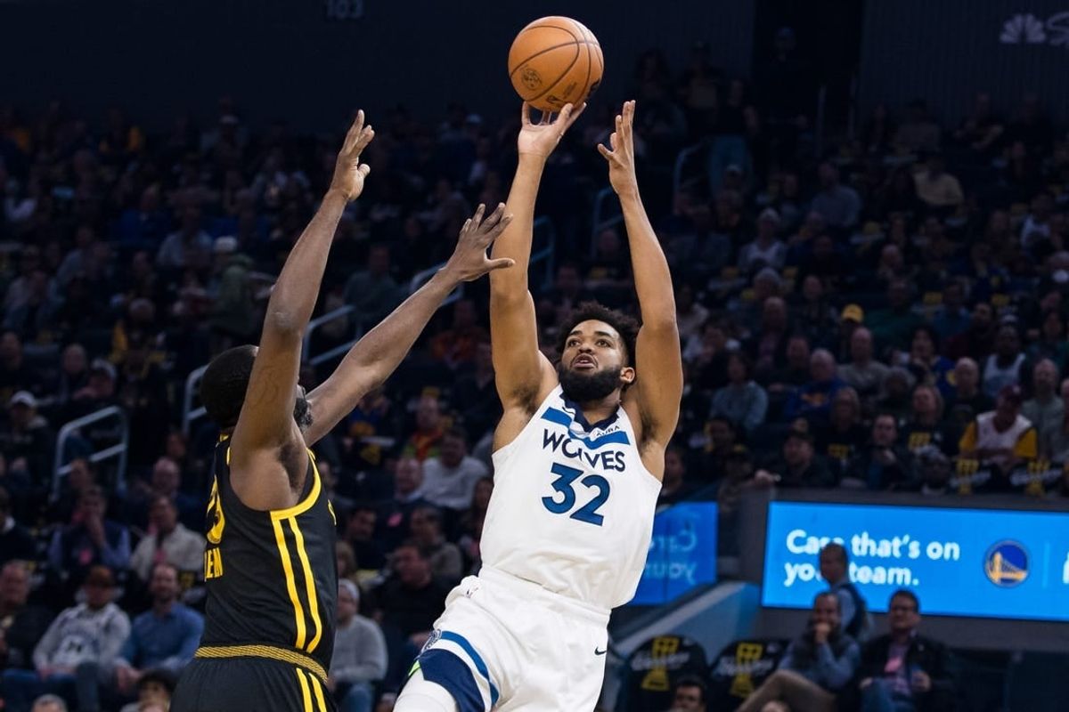 Nov 14, 2023; San Francisco, California, USA; Golden State Warriors forward Draymond Green (23) defends Minnesota Timberwolves forward Karl-Anthony Towns (32) during the first half at Chase Center.