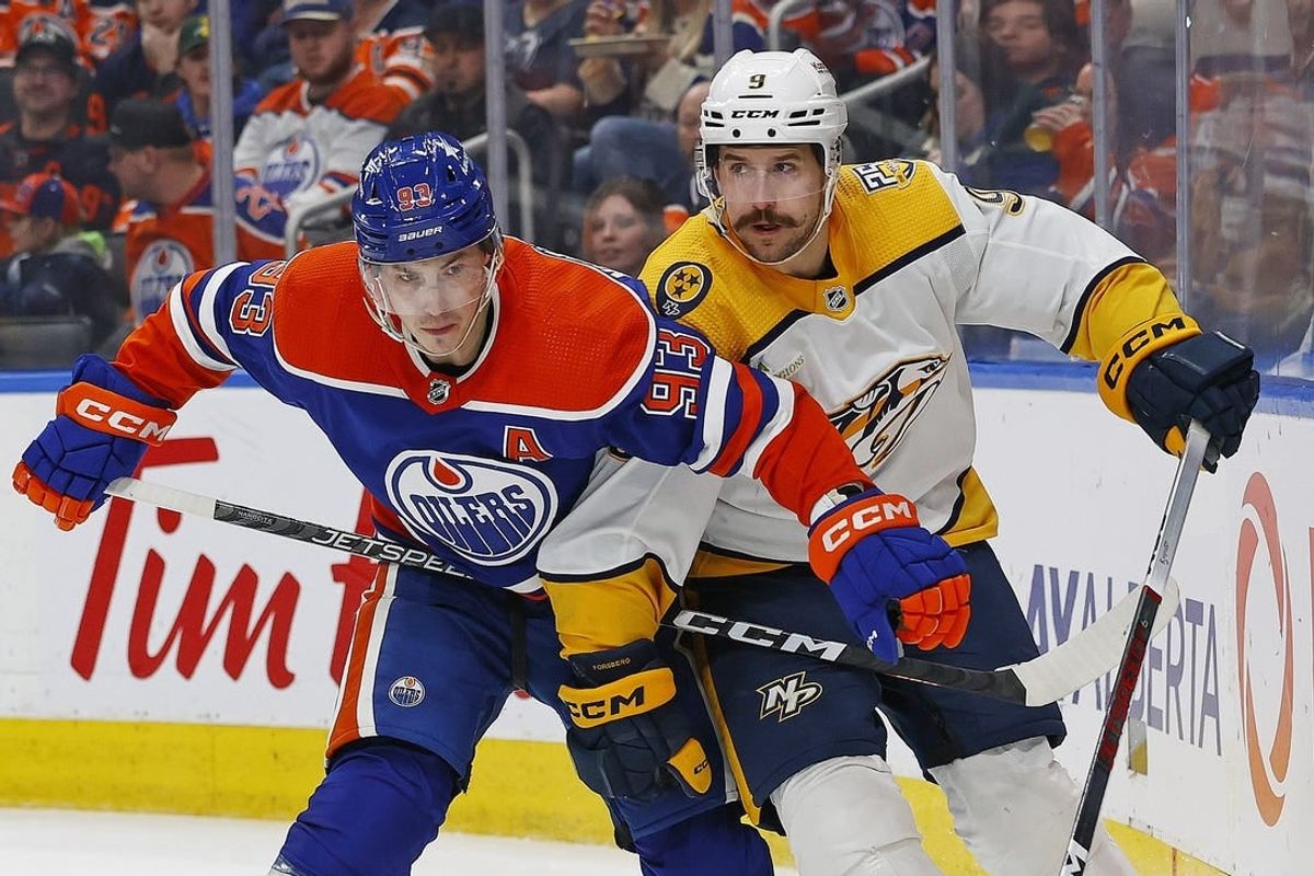 Jan 27, 2024; Edmonton, Alberta, CAN; Edmonton Oilers forward Ryan Nugent-Hopkins (93) and Nashville Predators forward Filip Forsberg (9) battle for position during the second period at Rogers Place.