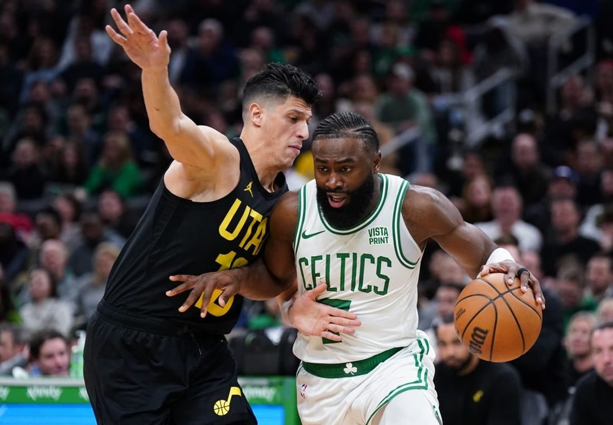 Jan 5, 2024; Boston, Massachusetts, USA; Boston Celtics guard Jaylen Brown (7) drives the ball against Utah Jazz forward Simone Fontecchio (16) in the second quarter at TD Garden.