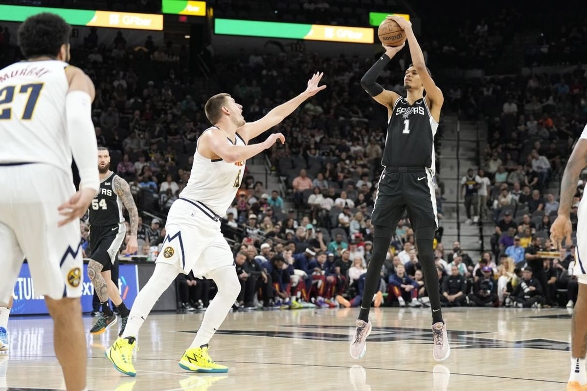 Apr 12, 2024; San Antonio, Texas, USA; San Antonio Spurs forward Victor Wembanyama (1) shoots over Denver Nuggets center Nikola Jokic (15) during the first half at Frost Bank Center.