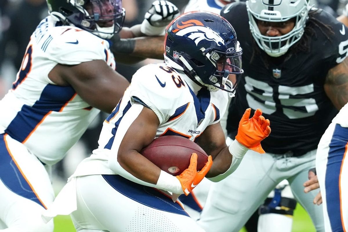 Jan 7, 2024; Paradise, Nevada, USA; Denver Broncos running back Javonte Williams (33) carries against the Las Vegas Raiders during the first quarter at Allegiant Stadium.