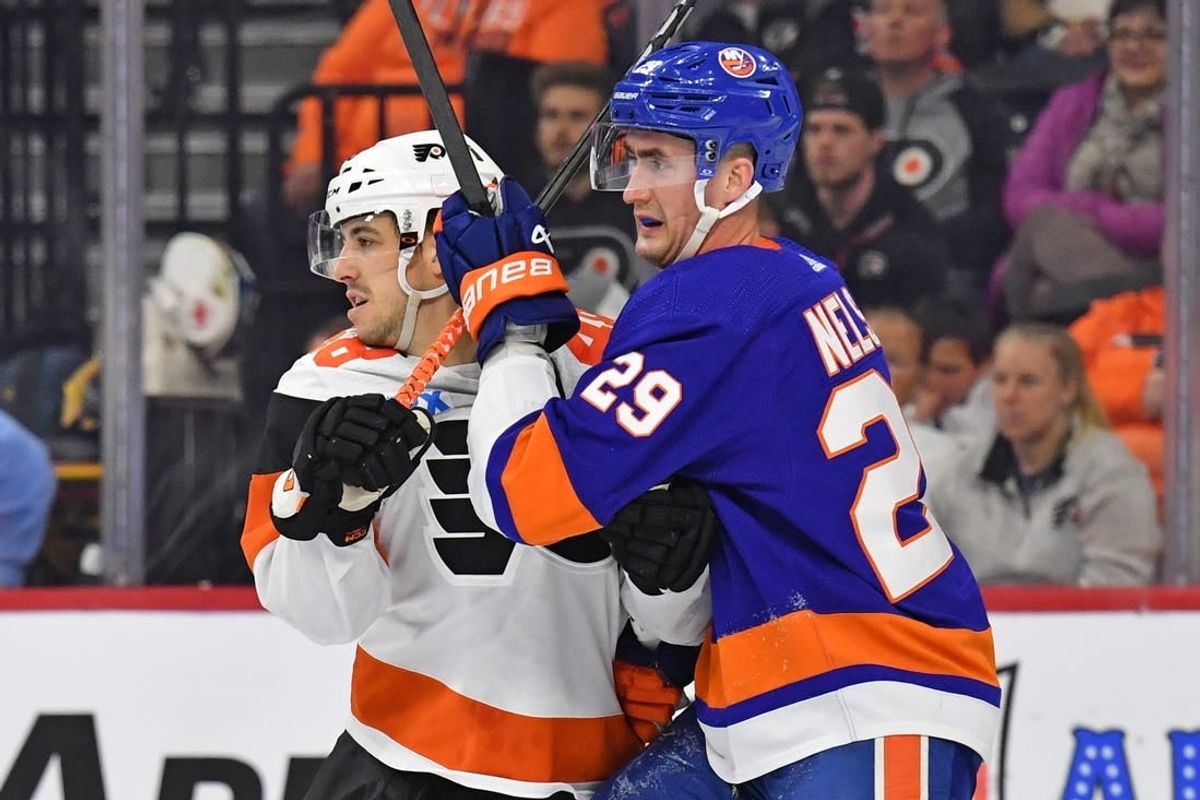 Apr 1, 2024; Philadelphia, Pennsylvania, USA; Philadelphia Flyers center Morgan Frost (48) and New York Islanders center Brock Nelson (29) battle for position during the second period at Wells Fargo Center.
